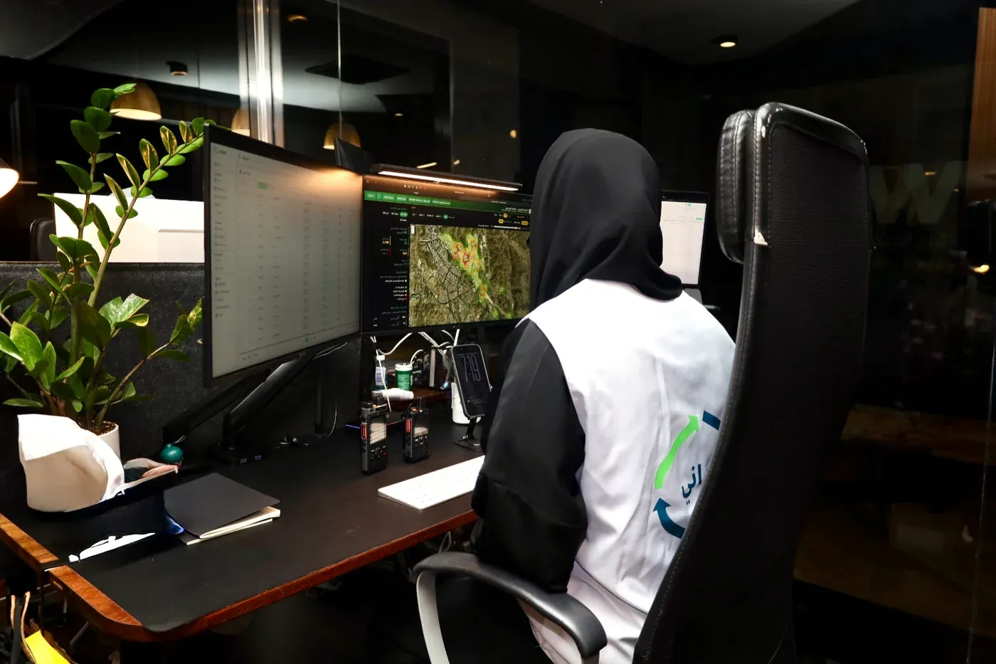 An operations desk: a live dashboard and a field map across two screens.