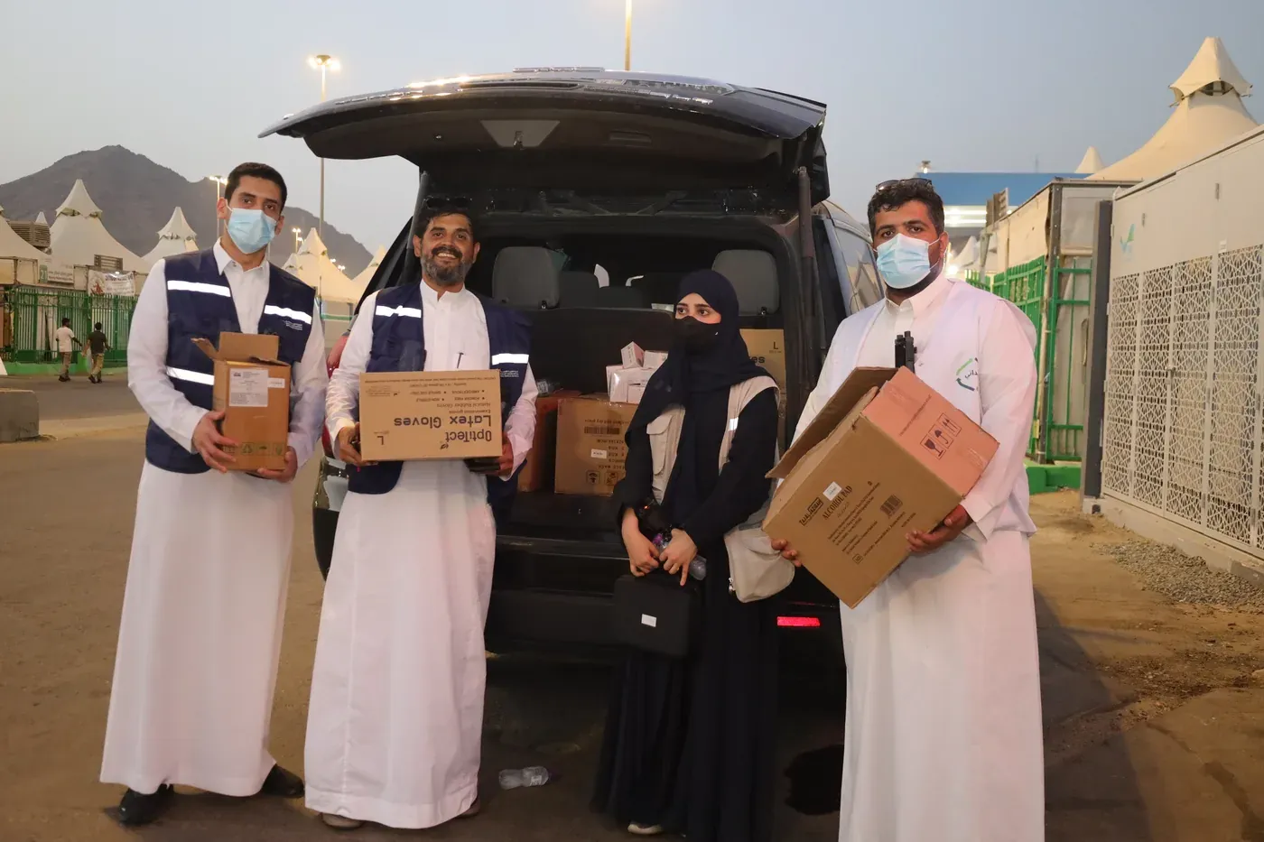 Part of the field team unloading medical supplies at a site.